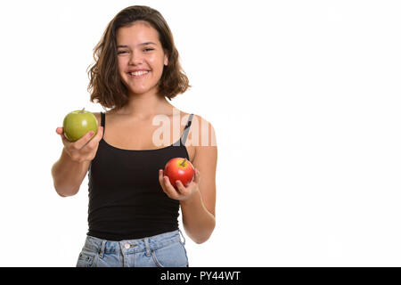 Young happy Caucasian teenage girl smiling holding red apple and Stock Photo
