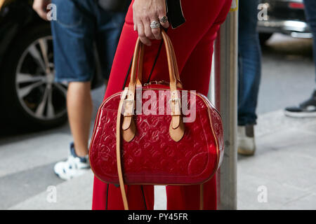 MILAN - SEPTEMBER 23: Woman with Louis Vuitton bag with pink and blue  flames looking at smartphone before Blumarine fashion show, Milan Fashion  Week s Stock Photo - Alamy