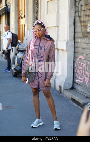 MILAN ITALY SEPTEMBER 23 2018 Woman with pink braids and brown Fila jacket before Fila fashion show Milan Fashion Week street style Stock Photo Alamy