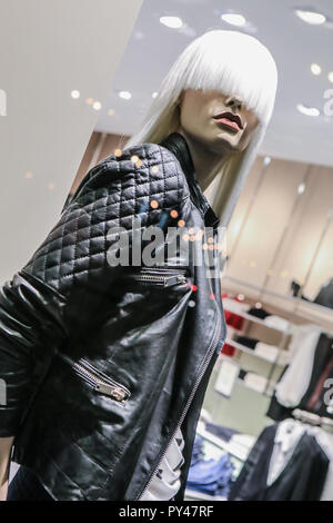 female dummy in fashionable clothes in shop show-window Stock Photo