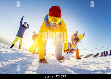 Funny photo with with friends at ski resort. Snowboarders are having fun in playful poses Stock Photo