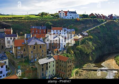 Taken from a high location, to capture an aerial view of the fishing village cottages, within the picturesque North Yorkshire location, of Staithes. Stock Photo