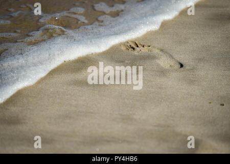 Detail shot with man footprints in the sand on a beach Stock Photo - Alamy