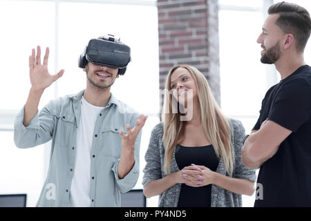 Positive colleagues testing virtual reality device Stock Photo