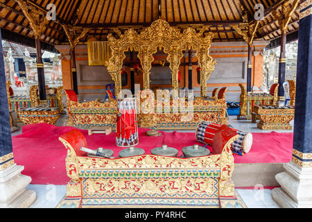 Bonang, gongs, kendangs and other traditional Indonesian musical instrument, a part of Gamelan. Stored in bale at Pura Kehen, Bangli, Indonesia. Stock Photo