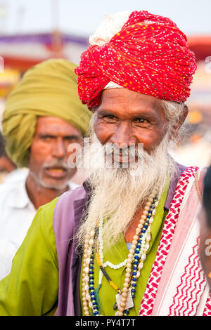 colourful elderly Indian man wearing red turban at the Pushkar festival Rajasthan,India Stock Photo