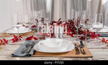white plate table setting on wooden table. Stock Photo