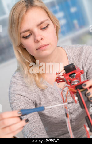 young engineer adjusting intelligence toy robot Stock Photo