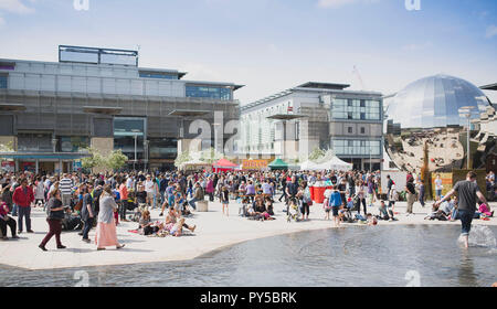 People walk around food stalls in Millennium Square during Food Connections festival, Bristol. Stock Photo