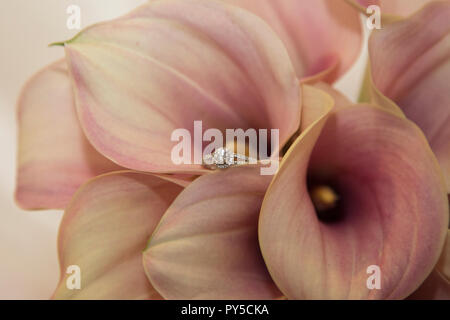 Engagement ring nestled in a brides bouquet on her wedding day Stock Photo