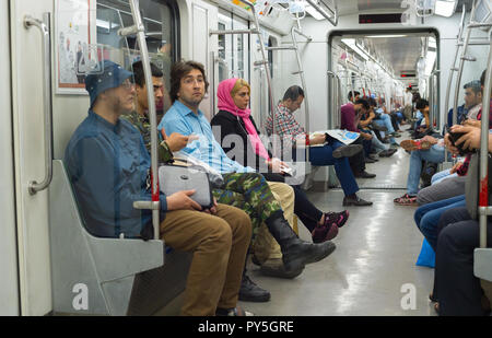 TEHRAN, IRAN - MAY 22, 2017: People at metro train in Tehran. The metro system consists of 7 operational metro lines Stock Photo