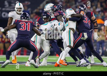 Houston, TX, USA. 25th Oct, 2018. Miami Dolphins running back Kalen Ballgage (27) is tackled by the Houston Texans during the first quarter at NRG Stadium in Houston, TX. John Glaser/CSM/Alamy Live News Stock Photo