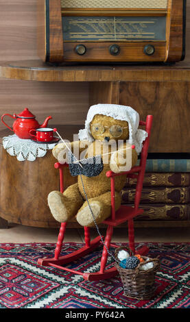 Teddy bear grandma knitting in a rocking chair in a vintage