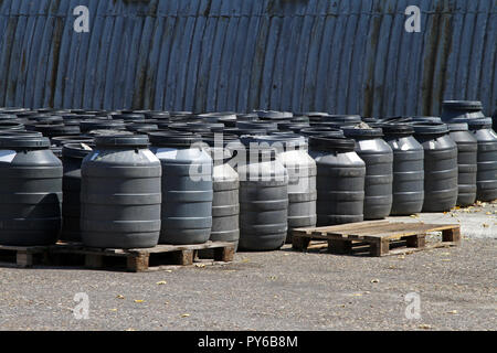 Industrial waiste in plastic barrels near warehouse Stock Photo