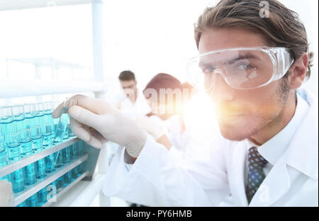 man in goggles to check fluid in vitro. Stock Photo