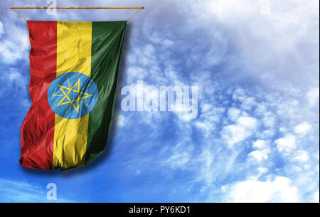 Flag of Ethiopia. Vertical flag, against blue sky with place for your text Stock Photo