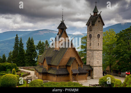 Vang stave church  , Poland , Karpacz. Historic, wooden church against the backdrop of mountains and blue sky Stock Photo