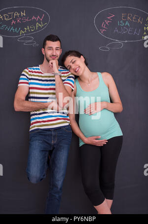 young pregnant couple thinking about names for their unborn baby and ...