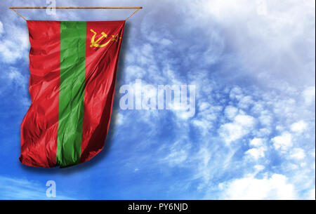 Flag of Transnistria. Vertical flag, against blue sky with place for your text Stock Photo