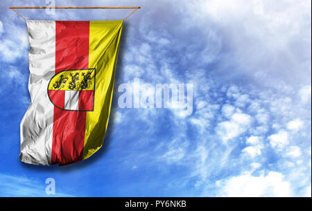 Flag of Carinthia. Vertical flag, against blue sky with place for your text Stock Photo