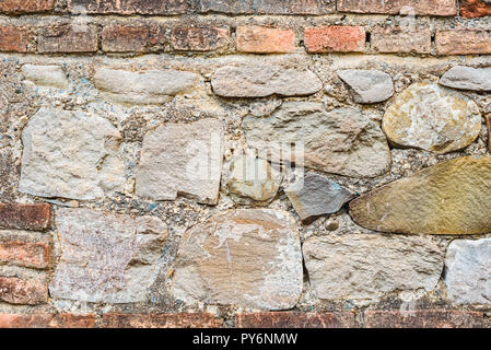 Ancient wall from big colourful square brick stones Stock Photo
