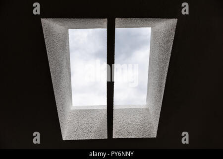 Looking up low angle through skylights in bathroom home kitchen house ceiling, sky and clouds Stock Photo