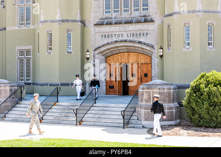 Lexington, USA - April 18, 2018: Virginia Military Institute cadets in uniform walking on green grass lawn during sunny day in front of Preston Librar Stock Photo