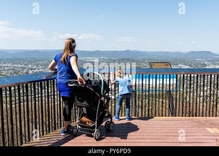 Roanoke, USA - April 18, 2018: View of city in Virginia during spring with sign, mountains, people family during sunny day Stock Photo