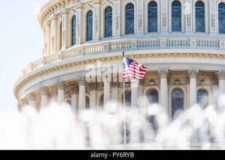 US Congress dome closeup with background of water fountain splashing, American flag waving in Washington DC, USA closeup on Capital capitol hill, colu Stock Photo
