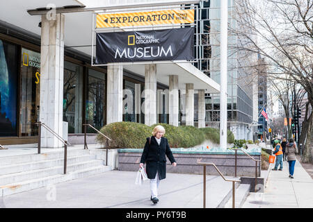 Washington DC, USA - March 9, 2018: National Geographic Museum sign, entrance with people, female, woman walking by street and building exterior Stock Photo