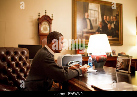 President Barack Obama reads one of 10 letters from the public selected for his personal reading from the volume of mail he receives. He sits at his desk in the Treaty Room Office in the Private Residence 2/22/09 Official White House Photo by Pete Souza Stock Photo