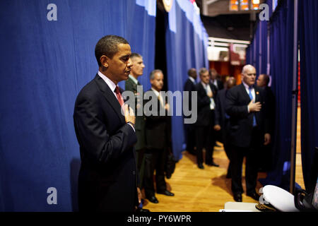 Before giving a policy speech on Iraq, President Barack Obama places his hand on his heart as the national anthem is played backstage  at the Field House, Camp Lejeune, North Carolina 2/27/09.  Official White House Photo by Pete Souza Stock Photo