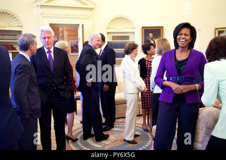 President Barack Obama, background, and First Lady Michelle Obama greet guests in the Oval Office April 21, 2009, including former President Bill Clinton, U.S. Senator Edward M. Kennedy, former first  lady Rosalynn Carter, center, along with Vice President Joe Biden. Official White House Photo by Pete Souza Stock Photo