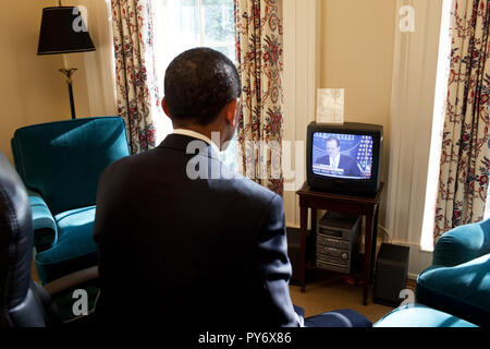 President Obama watches Press Secretary Robert Gibbs' first Press Briefing on television, in his private study off the Oval Office 1/22/09.  White House Official Photo by Joyce N. Boghosian Stock Photo