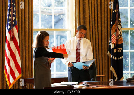 President Barack Obama looks at daily correspondence in the Oval Office with his personal secretary Katie Johnson 1/30/09. Official White House Photo by Pete Souza Stock Photo