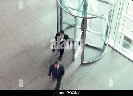 Businessmen in office building revolving door, USA  1991 Stock Photo