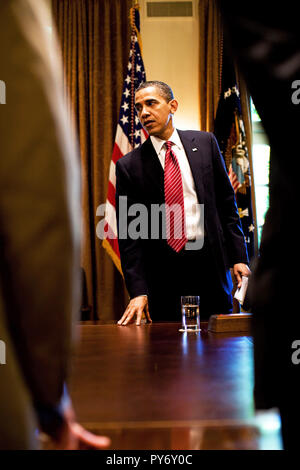 President Barack Obama stands as he prepares to leave an outreach meeting in the Roosevelt Room, May 20, 2009. (Official White House photo by Pete Souza)  This official White House photograph is being made available for publication by news organizations and/or for personal use printing by the subject(s) of the photograph. The photograph may not be manipulated in any way or used in materials, advertisements, products, or promotions that in any way suggest approval or endorsement of the President, the First Family, or the White House. Stock Photo