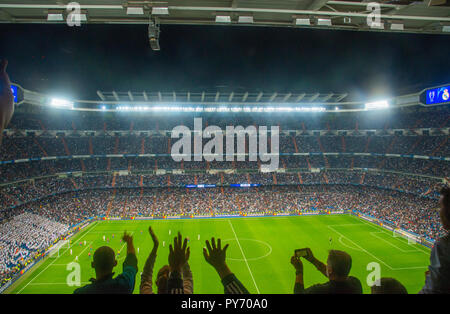 Champions League football match, people celebrating a goal. Santiago Bernabeu stadium, Madrid, Spain. Stock Photo
