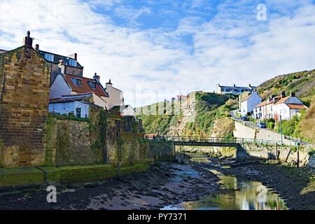 Capturing an idyllic sunny autumn day along the picturesque harbour of the North Yorkshire coast village of Staithes. Stock Photo