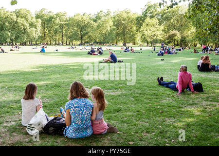 London England,UK,United Kingdom Great Britain,Green Park,Ritz Corner,Royal Parks,lawn,outdoors,green space,sitting seated on grass,adult adults woman Stock Photo