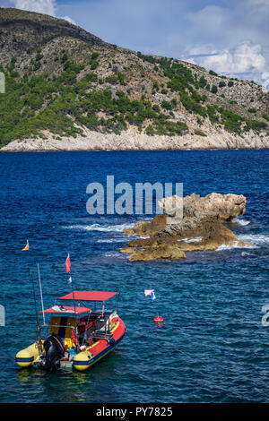 rigid-hulled inflatable boat in Cala Agulla bay and in front of mountain Es Telégraf, near Cala Rajada, Capdepera, Mallorca, Balearic Islands, Spain Stock Photo