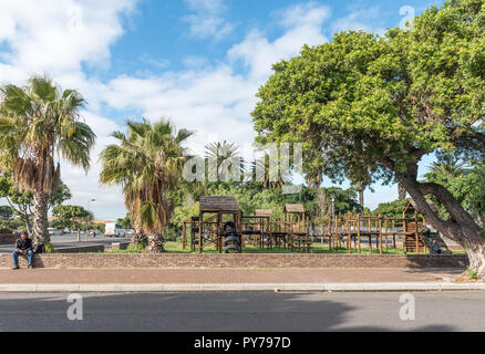 GOODWOOD, SOUTH AFRICA, AUGUST 14, 2018: A street scene with a playpark in Goodwood in the Western Cape Province. People are visible Stock Photo