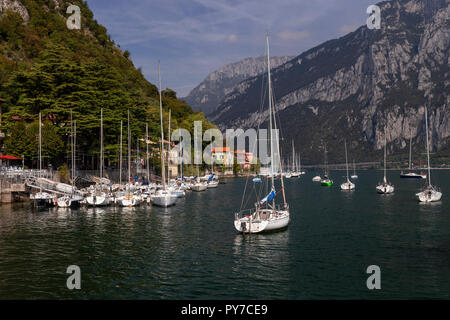 Boats at Valmedrera harbour on Lake Como, Italy, with mountains Stock Photo