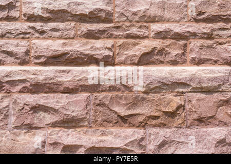 Granite block wall background on building facade Stock Photo
