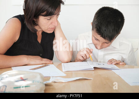 UK,Mother helps 11 years old boy with exams revision Stock Photo