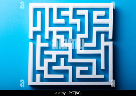 High Angle View Of White Maze On Blue Background Stock Photo