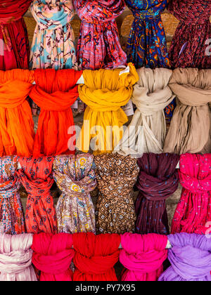 Shop display of colourful scarves tied on rails outside a ladies fashion store shop Stock Photo