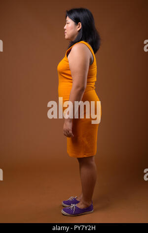 Full length profile view of beautiful overweight Asian woman Stock Photo
