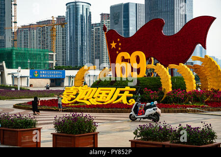 Chinese tourists taking photo in front of funny 69 sign Stock Photo