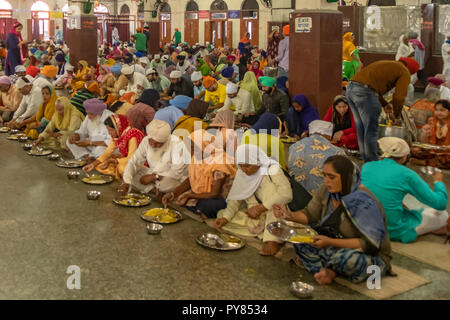 Eating Food at Langar Hall Community Kitchen,. Amritsar, Punjab, India Stock Photo